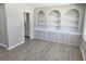 Bright room with built-in shelves and cabinets set in a brick frame with vinyl plank flooring at 159 Foxborough Rd, Goose Creek, SC 29445