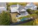 Aerial view of backyard with privacy fence, pool, seating, tropical landscaping, and a screened-in porch at 171 Cartright St, Charleston, SC 29492