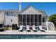 Relaxing backyard pool with lounge chairs, a screened porch, and outdoor entertaining space at 171 Cartright St, Charleston, SC 29492