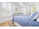 Bright bedroom features natural light, blue bedding, and hardwood floors at 171 Cartright St, Charleston, SC 29492