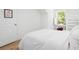 Bright, airy bedroom with white walls, window view, and hardwood floors at 171 Cartright St, Charleston, SC 29492