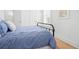 Bright bedroom featuring hardwood floors, a blue duvet, white walls, and natural light at 171 Cartright St, Charleston, SC 29492