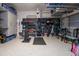 Organized garage featuring epoxy floor, wall racks, shelves, tools, and fitness equipment at 171 Cartright St, Charleston, SC 29492