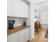 Kitchen features a coffee bar with butcher block countertop and shaker style cabinets at 171 Cartright St, Charleston, SC 29492