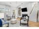 Living room with a fireplace, built-in bookshelves, and lots of natural light at 171 Cartright St, Charleston, SC 29492