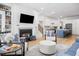 Cozy living room with a fireplace, built-in bookshelves, and an open floor plan to the modern kitchen at 171 Cartright St, Charleston, SC 29492