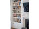 Living room with fireplace and custom-built shelving featuring a variety of books and decor at 171 Cartright St, Charleston, SC 29492