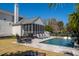 Inviting backyard pool with a screened porch and deck chairs, perfect for relaxation and outdoor enjoyment at 171 Cartright St, Charleston, SC 29492