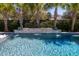 Backyard pool with a waterfall feature, lush landscaping, and serene ambiance at 171 Cartright St, Charleston, SC 29492