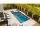 This backyard oasis features a luxurious pool with travertine patio, mature palms and ample seating at 171 Cartright St, Charleston, SC 29492