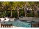 Inviting pool with palm trees and tanning chairs offers the perfect spot to unwind in a backyard oasis at 171 Cartright St, Charleston, SC 29492