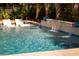 Backyard pool with in-water seating and a waterfall feature creates a luxurious and relaxing retreat at 171 Cartright St, Charleston, SC 29492