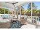 Screened porch with wicker furniture, ceiling fan, string lights, and pool view at 171 Cartright St, Charleston, SC 29492