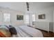 Cozy main bedroom featuring white walls, hardwood floors, and an ensuite bathroom at 1728 Barracuda Rd, Johns Island, SC 29455