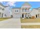 Charming two-story home featuring a welcoming front porch and a well-manicured lawn at 187 Red Blf St, Summerville, SC 29483