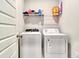 Laundry room with white washer and dryer and storage shelf at 187 Red Blf St, Summerville, SC 29483