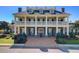 Stately building with a two-story columned facade and dormer windows offers a grand and impressive presence at 1896 Palmetto Isle Dr, Mount Pleasant, SC 29466