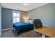 Bedroom featuring a blue bed, wood desk, and natural light from the window at 1926 Grimball Rd, Charleston, SC 29412