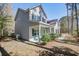Charming two-story home featuring a welcoming front porch with blue chairs and lush landscaping at 1926 Grimball Rd, Charleston, SC 29412