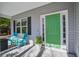 A charming front porch with colorful chairs and potted plants provides a welcoming entrance to the home at 1926 Grimball Rd, Charleston, SC 29412