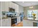Beautiful kitchen featuring stainless steel appliances, granite countertops, and white cabinets with modern hardware at 1926 Grimball Rd, Charleston, SC 29412