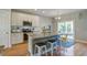 Bright kitchen with stainless appliances, white cabinets, granite countertops, and a large island with seating at 1926 Grimball Rd, Charleston, SC 29412