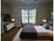 Comfortable bedroom with hardwood floors, neutral colors, and a large window at 212 Regent St, Summerville, SC 29483