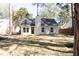 Charming single-Gathering home with neutral siding, black front door, and a well-manicured lawn at 212 Regent St, Summerville, SC 29483