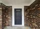 Close-up of the home's black front door with white trim and decorative black sconces at 212 Regent St, Summerville, SC 29483