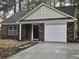 Charming one-story brick home featuring an attached garage and a well-manicured lawn at 212 Regent St, Summerville, SC 29483