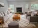 Bright living room with neutral decor, fireplace and hardwood floors at 212 Regent St, Summerville, SC 29483