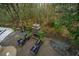 Aerial view of a patio with a stone fireplace, seating area, and lush landscaping, offering an inviting outdoor space at 2415 Jasper Patterson Dr, Johns Island, SC 29455