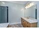 Well-lit bathroom featuring a walk-in shower and vanity with marble countertop at 2415 Jasper Patterson Dr, Johns Island, SC 29455
