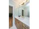 Bright bathroom with white countertops, wooden cabinets, bronze hardware, and open doorway to another room at 2415 Jasper Patterson Dr, Johns Island, SC 29455
