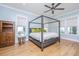 Serene bedroom featuring a four-poster bed, hardwood floors, neutral decor, and ample natural light from the windows at 2415 Jasper Patterson Dr, Johns Island, SC 29455