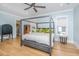 Spacious bedroom featuring a stylish canopy bed, hardwood floors and large windows at 2415 Jasper Patterson Dr, Johns Island, SC 29455