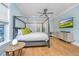Bright bedroom with hardwood floors, a canopy bed and a wall-mounted TV at 2415 Jasper Patterson Dr, Johns Island, SC 29455