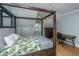 This bedoom features a canopy bed, hardwood floors and natural light from two windows at 2415 Jasper Patterson Dr, Johns Island, SC 29455