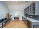 Bonus room featuring a wet bar, golf clubs, workspace, wood floors, and lots of natural light at 2415 Jasper Patterson Dr, Johns Island, SC 29455