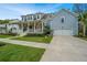 Charming two-story home featuring a welcoming front porch, manicured lawn, and an attached garage at 2415 Jasper Patterson Dr, Johns Island, SC 29455