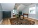 Bright home office with sloped ceilings, hardwood floors, decorative rug, black cabinets, and stylish desk with comfortable chair at 2415 Jasper Patterson Dr, Johns Island, SC 29455