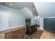 Bright home office with sloped ceilings, hardwood floors, decorative rug, black cabinets, and stylish desk with comfortable chair at 2415 Jasper Patterson Dr, Johns Island, SC 29455