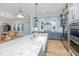 Bright open kitchen featuring a large island, stainless appliances, marble countertops, and a view of the dining area at 2415 Jasper Patterson Dr, Johns Island, SC 29455