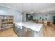 Bright kitchen showcasing a large island with a sink, and a stainless steel dishwasher, with an open concept living space at 2415 Jasper Patterson Dr, Johns Island, SC 29455