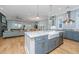 Spacious open kitchen with an island, stainless steel appliances, marble countertops, and a view into the living area at 2415 Jasper Patterson Dr, Johns Island, SC 29455