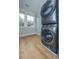 This laundry room features a stacked washer and dryer unit and natural light from the window at 2415 Jasper Patterson Dr, Johns Island, SC 29455