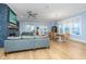Bright living room with hardwood floors, comfortable seating, a stone fireplace, and a view of the dining area at 2415 Jasper Patterson Dr, Johns Island, SC 29455
