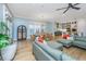 Bright open-concept living space featuring hardwood floors, modern furnishings, and a seamless flow to the dining and kitchen areas at 2415 Jasper Patterson Dr, Johns Island, SC 29455