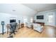 Spacious living room with hardwood floors, tv, desk, office chair, and lounge chairs at 2415 Jasper Patterson Dr, Johns Island, SC 29455