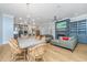 Open-concept living room featuring hardwood floors, a stone fireplace, dining area, and a view into the kitchen at 2415 Jasper Patterson Dr, Johns Island, SC 29455